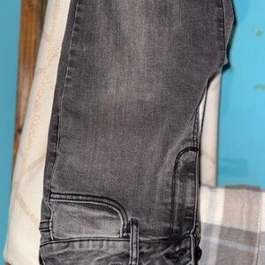 Black straight leg jeans ripped at the bottom